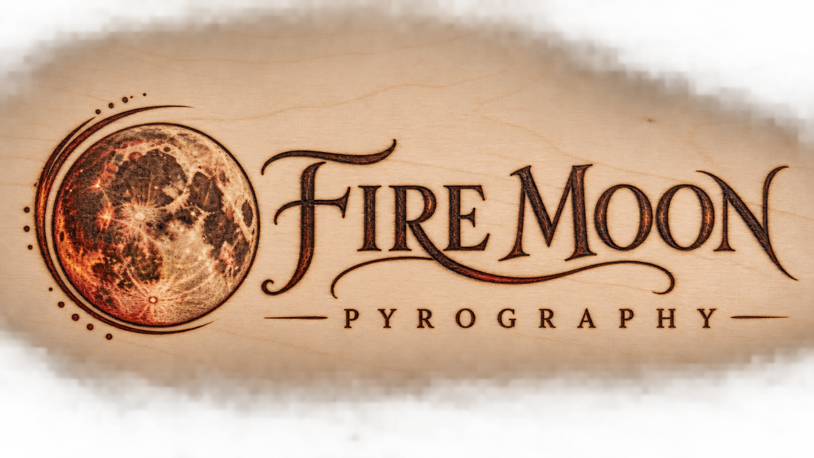 Fire Moon Pyrography logo concept burned into pale wood